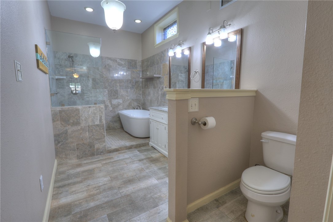 3141 Baybrook Drive Corpus Christi, TX 78418 - Photo 17 of 32 a bathroom with a toilet a sink and mirror