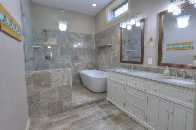a bathroom with a granite countertop sink a toilet a mirror and vanity