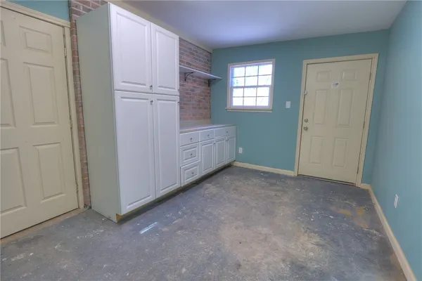 an empty room with windows and closet