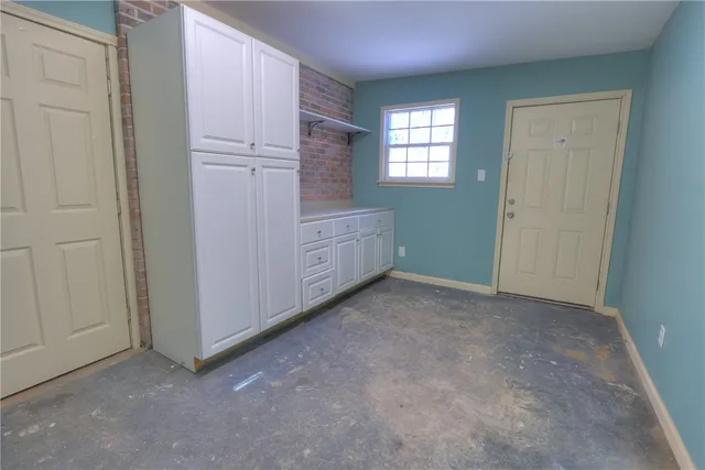 an empty room with windows and closet