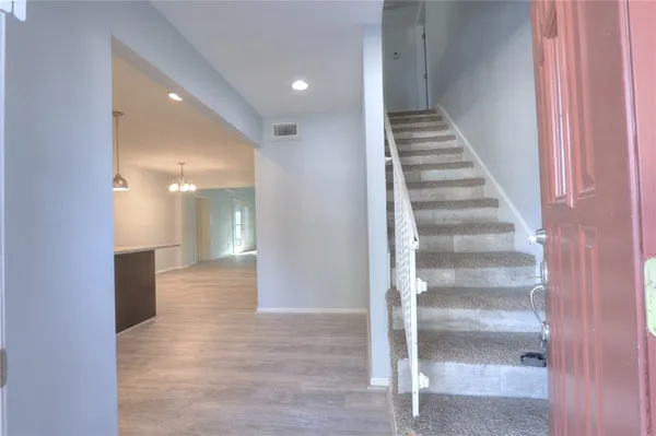 a view of an entryway with wooden floor