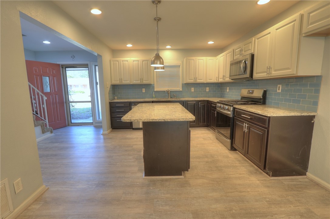 3141 Baybrook Drive Corpus Christi, TX 78418 - Photo 8 of 32 a kitchen with stainless steel appliances granite countertop a stove a sink a refrigerator and a microwave