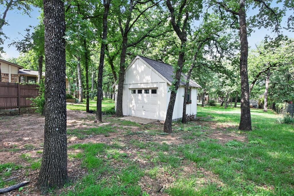 1607 North Main Street Euless, TX 76039 - Photo 20 of 39 a view of a house with a tree in a forest