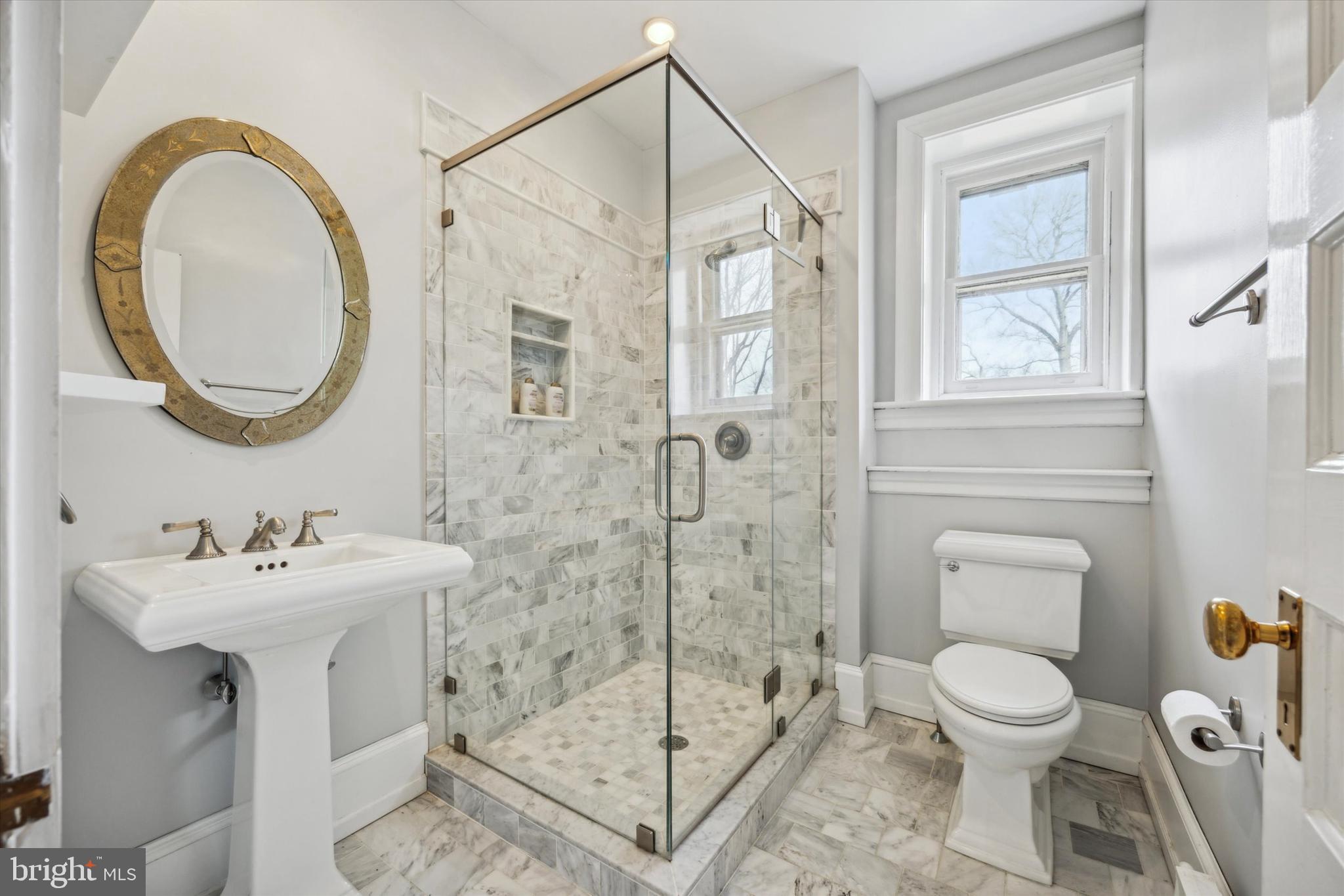 226 Fishers Road Bryn Mawr, PA 19010 - Photo 21 of 60 a bathroom with a sink a toilet and a mirror
