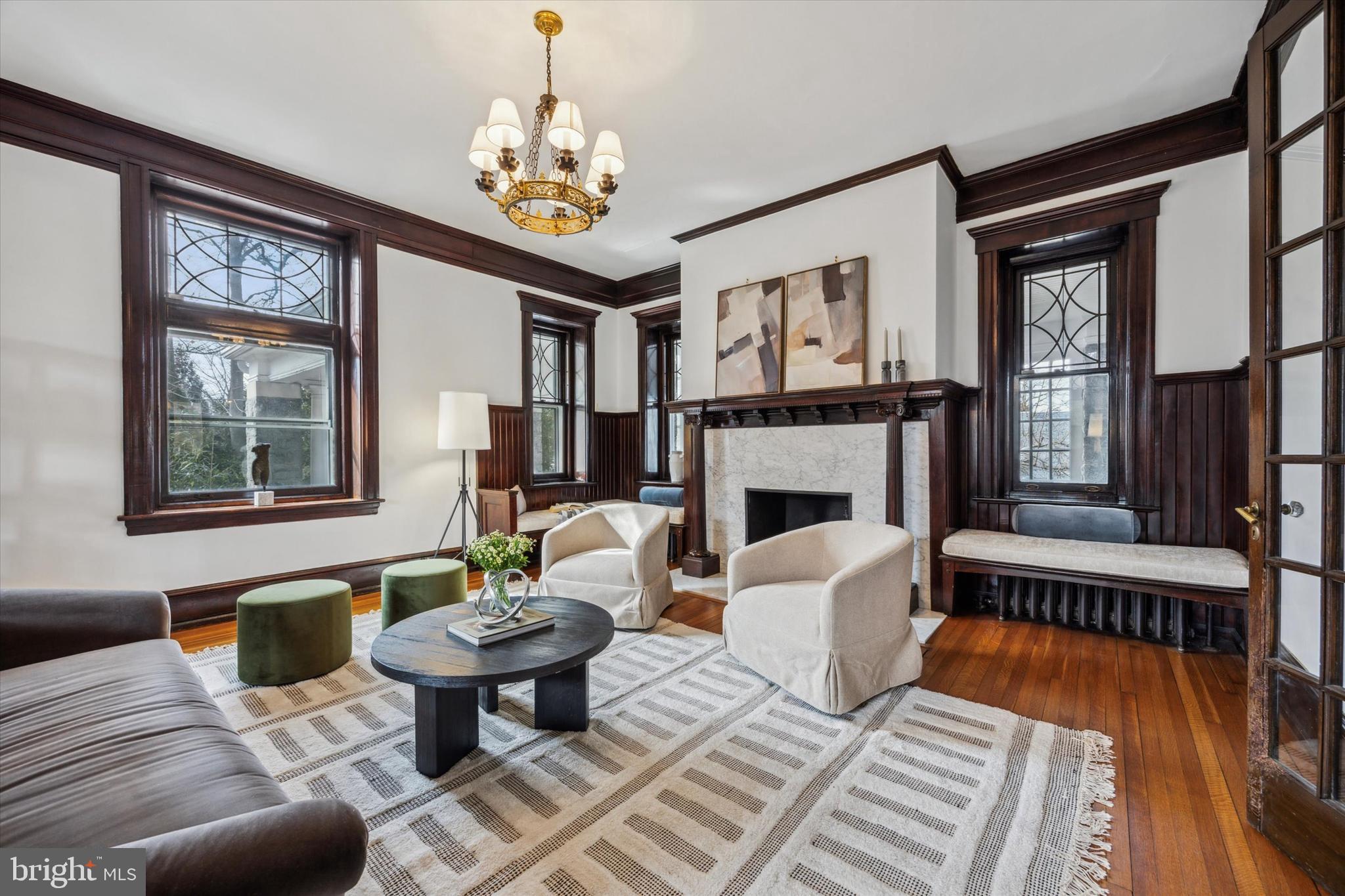 226 Fishers Road Bryn Mawr, PA 19010 - Photo 4 of 60 a living room with furniture a chandelier and a fireplace