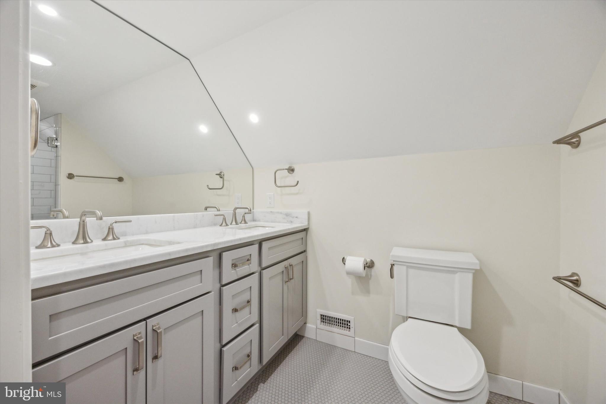 226 Fishers Road Bryn Mawr, PA 19010 - Photo 48 of 60 a bathroom with a granite countertop toilet sink and mirror