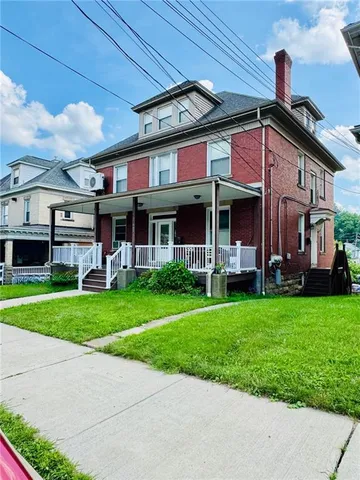 a view of a house with a yard porch and sitting area