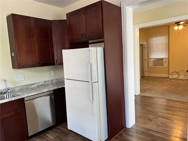 a white refrigerator freezer sitting inside of a kitchen