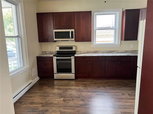 a kitchen with stainless steel appliances granite countertop a sink and a stove top oven