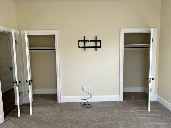 a view of a livingroom with a hall and wooden floor