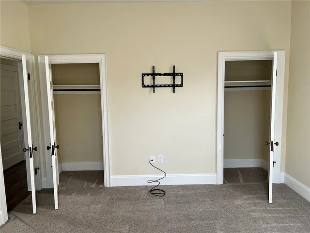 a view of a livingroom with a hall and wooden floor