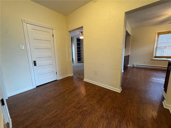 an empty room with wooden floor and closet