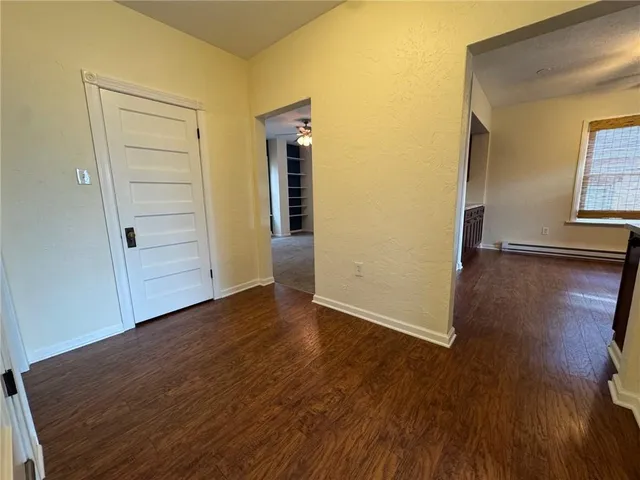 an empty room with wooden floor and closet
