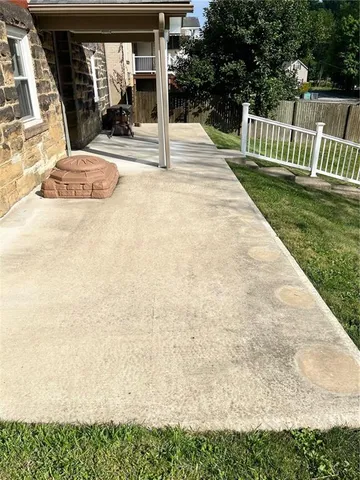 a view of a backyard with wooden fence