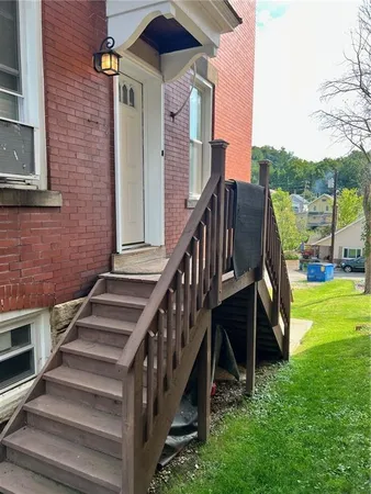 a view of a house with backyard and deck