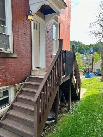 a view of a house with backyard and deck