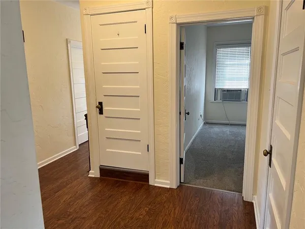 a view of a hallway with wooden floor