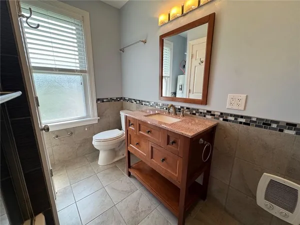 a bathroom with a sink toilet and mirror