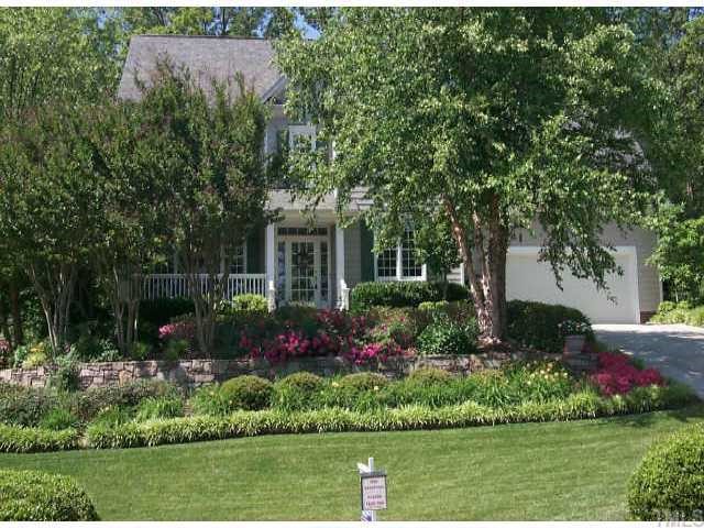 7709 Wilderness Road Raleigh, NC 27613 - Photo 1 of 8 a view of a garden with flowers and trees