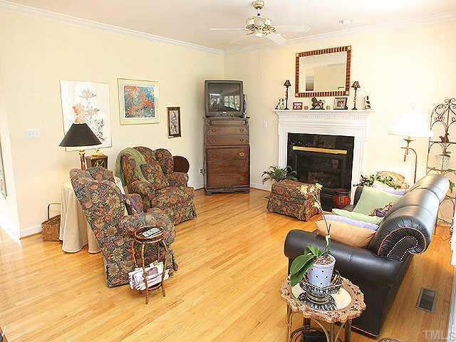 7709 Wilderness Road Raleigh, NC 27613 - Photo 2 of 8 a living room with furniture and a fireplace
