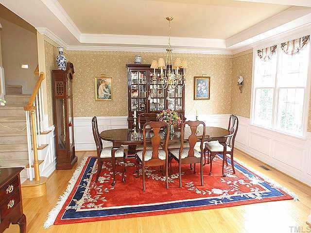 7709 Wilderness Road Raleigh, NC 27613 - Photo 3 of 8 a view of a dining room with furniture window and wooden floor