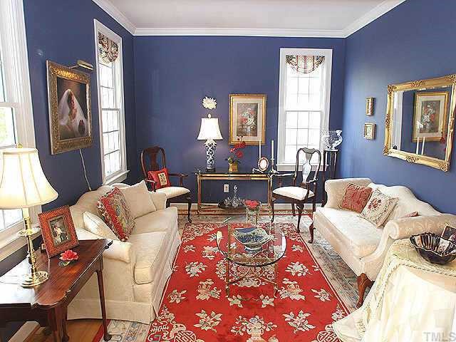 7709 Wilderness Road Raleigh, NC 27613 - Photo 5 of 8 a living room with furniture and a window