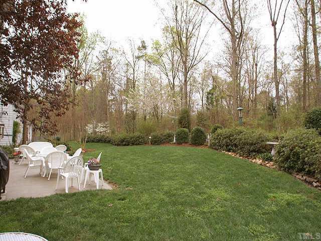 7709 Wilderness Road Raleigh, NC 27613 - Photo 8 of 8 a view of a chair and table on the garden