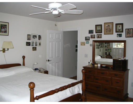 34 Shattuck Street Groton, MA 01450 - Photo 10 of 10 a bedroom with a bed and a chandelier