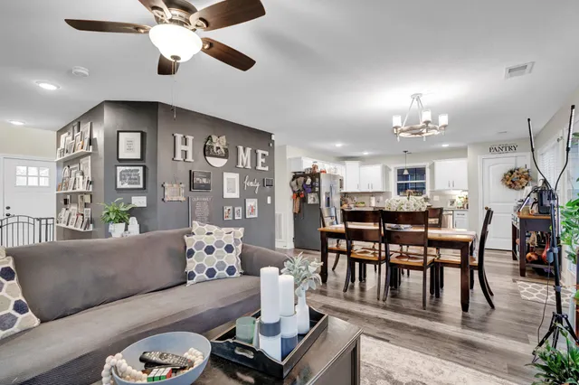 a living room with furniture and a chandelier