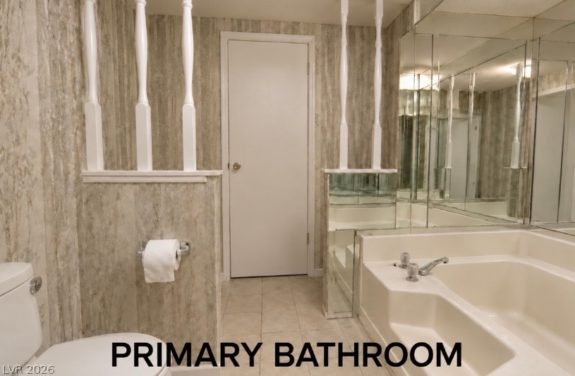 4556 Royal Ridge Way Las Vegas, NV 89103 - Photo 17 of 49 A spacious soaking tub anchors this well-proportioned primary bathroom featuring tiled flooring.