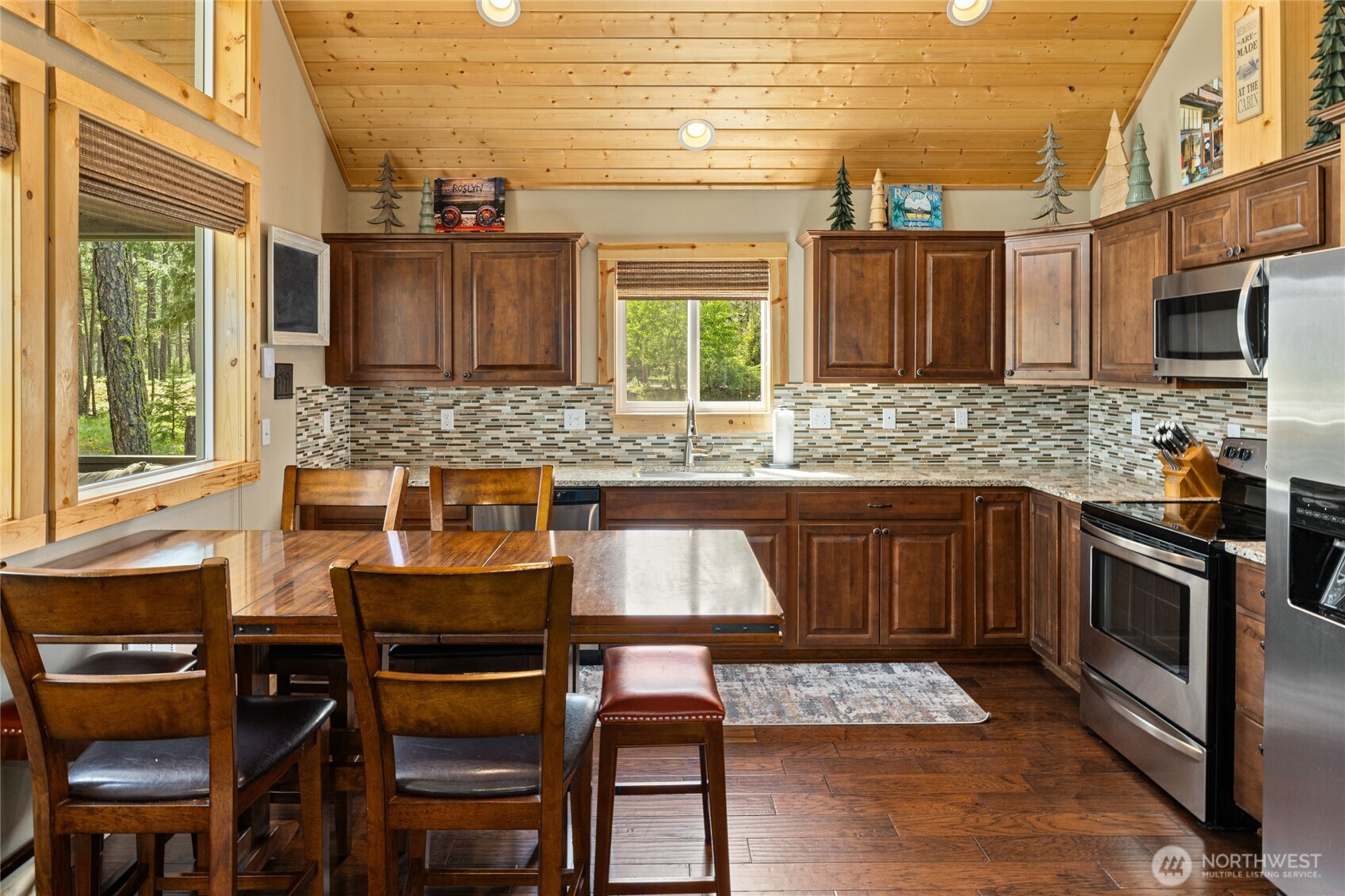 910 Bakers Road Ronald, WA 98940 - Photo 21 of 34 a kitchen with granite countertop a stove a sink and chairs
