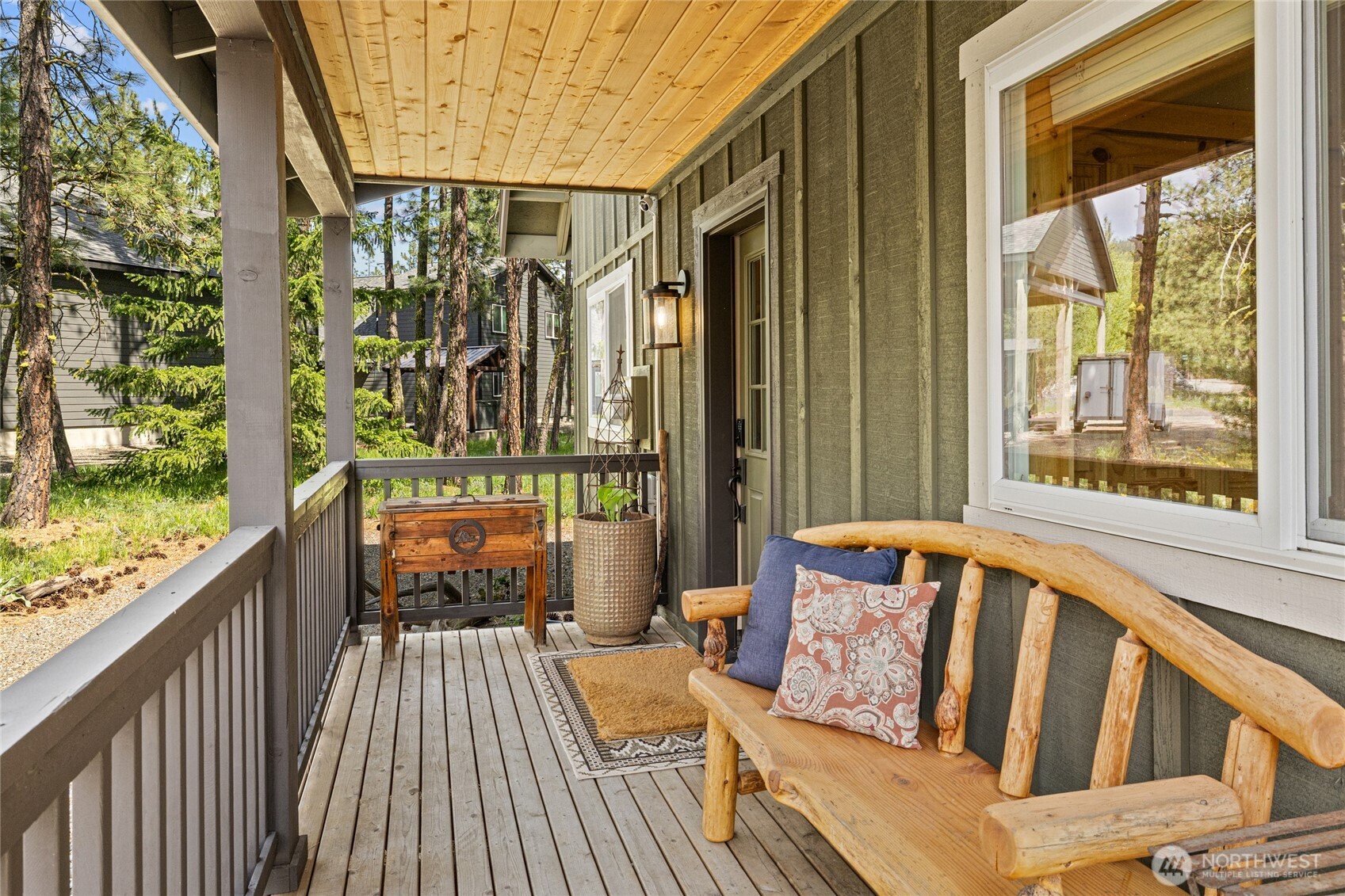 910 Bakers Road Ronald, WA 98940 - Photo 8 of 34 a balcony of a house with wooden floor outdoor seating and furniture