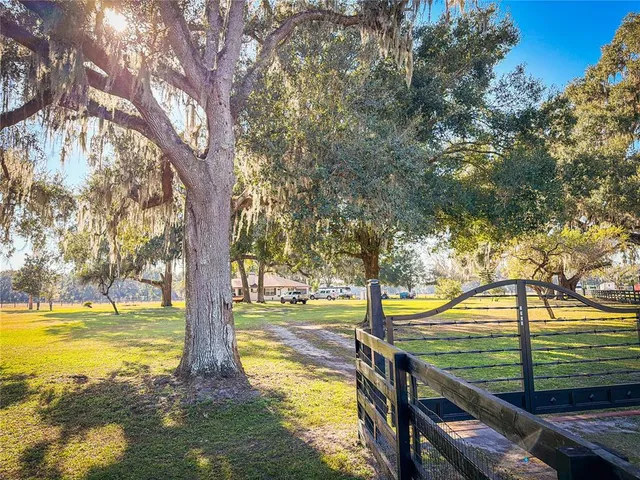 a view of a yard with swimming pool and sitting area