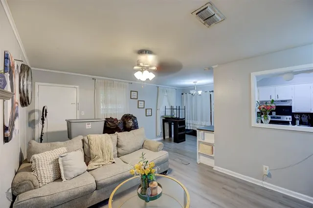 a living room with furniture and a chandelier