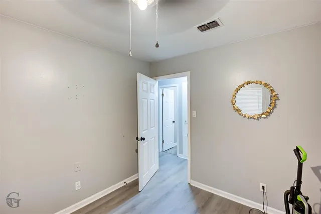 a view of a room with wooden floor