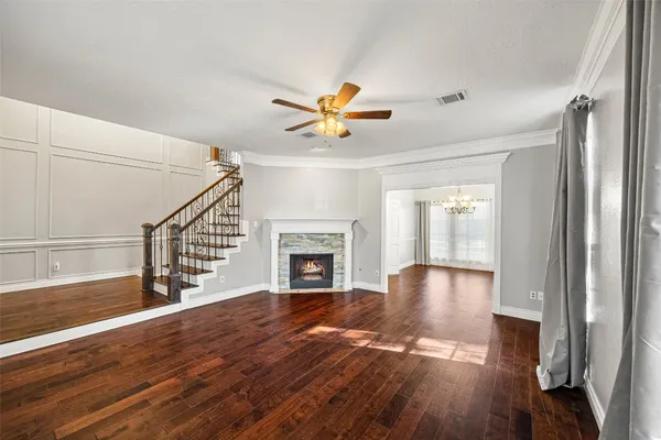 a living room with furniture and ceiling fan