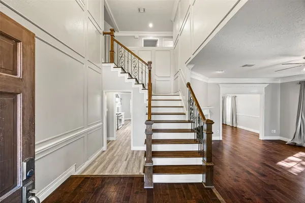 a view of entryway with wooden floor and stairs