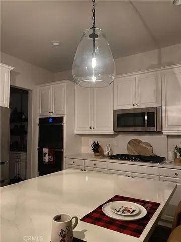 a kitchen with a stove a refrigerator and a sink