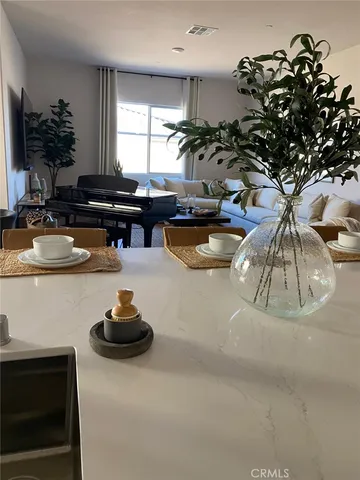 a kitchen with a sink a counter and a living room view
