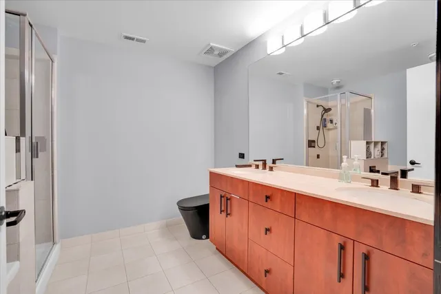 a spacious bathroom with a double vanity sink mirror and double