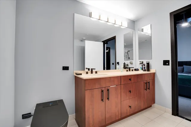 a bathroom with a sink vanity and mirror