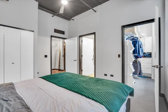 a bedroom with a bed and a painting on the wall