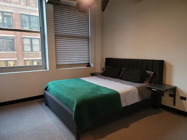 a bedroom with a bed and window