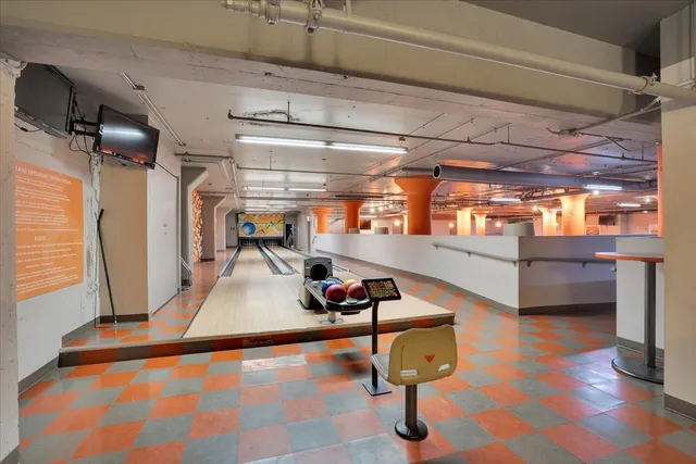 a room with lots of wooden furniture and windows