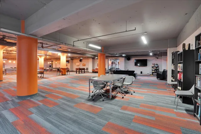 a view of a room with gym equipment and windows