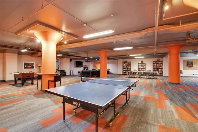 a view of a room with furniture and wooden floor