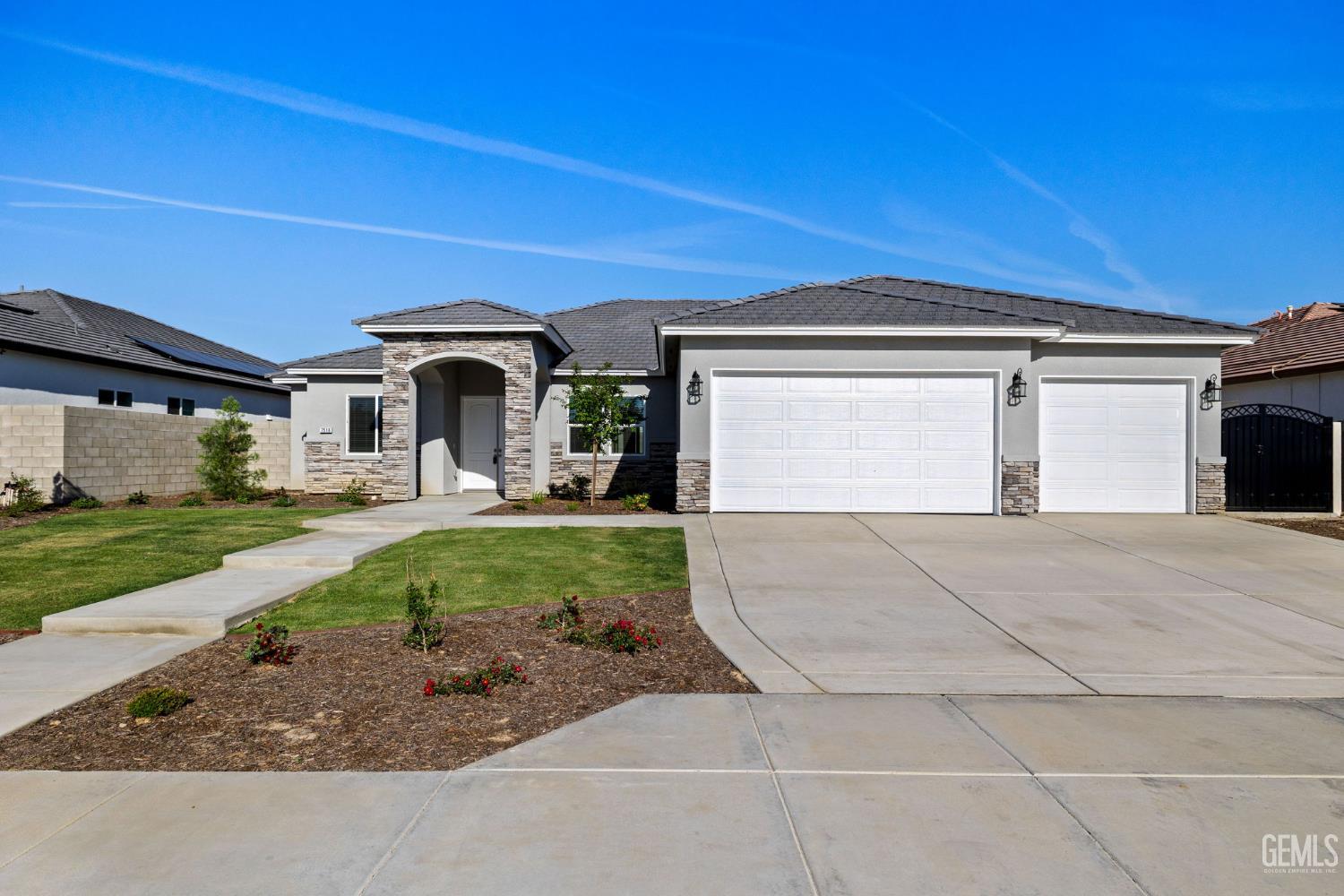 Undisclosed Address Bakersfield, CA 93314 - Photo 4 of 55 a front view of a house with a yard and garage