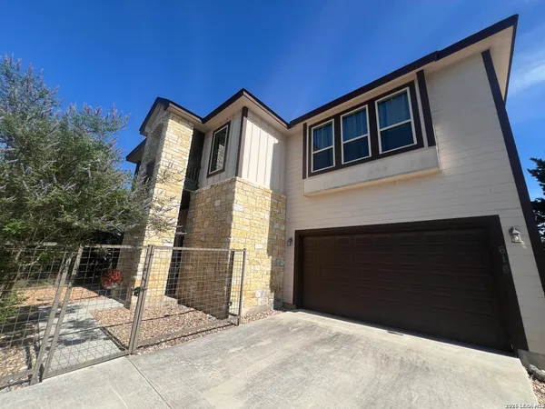 a front view of a house with garage