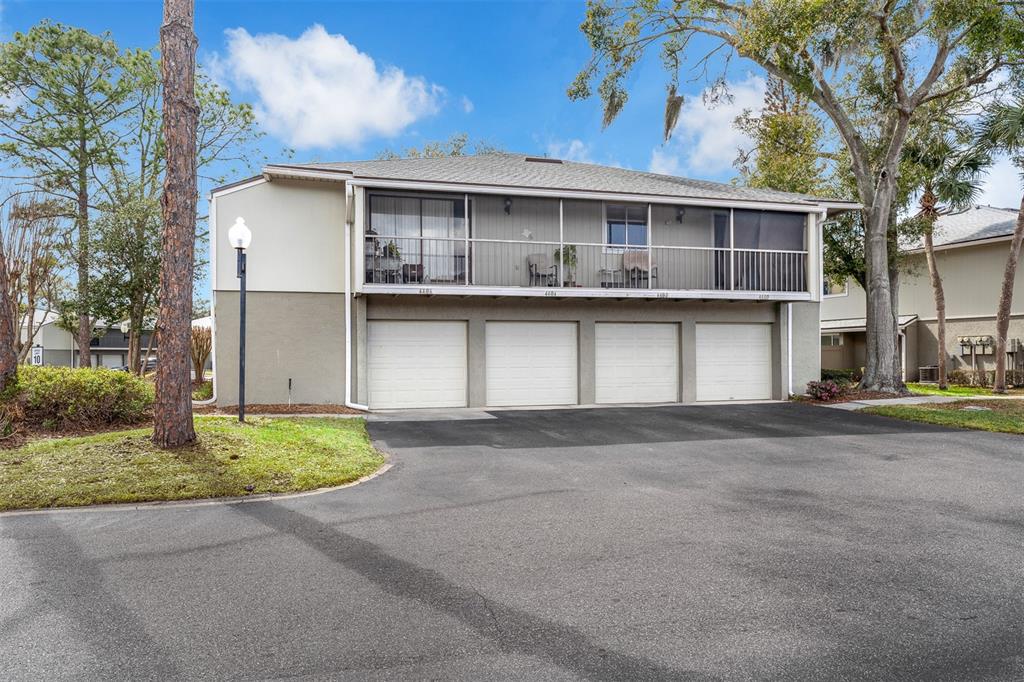 4402 Ring Neck Road, Unit 19B Orlando, FL 32808 - Photo 1 of 35 a front view of a house with a yard and garage
