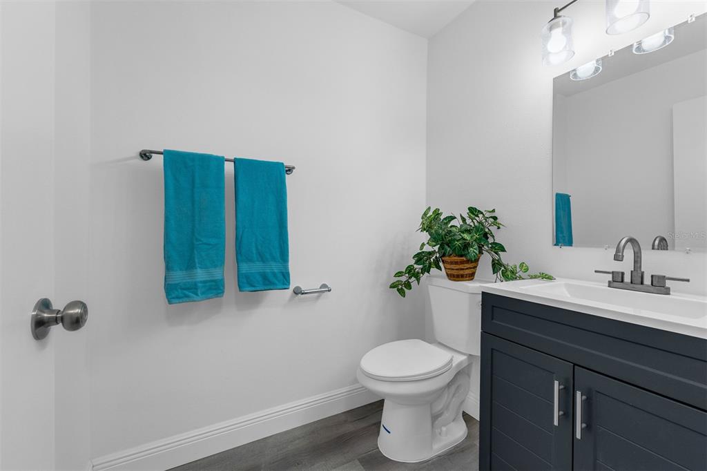 4402 Ring Neck Road, Unit 19B Orlando, FL 32808 - Photo 12 of 35 a bathroom with a toilet sink and mirror